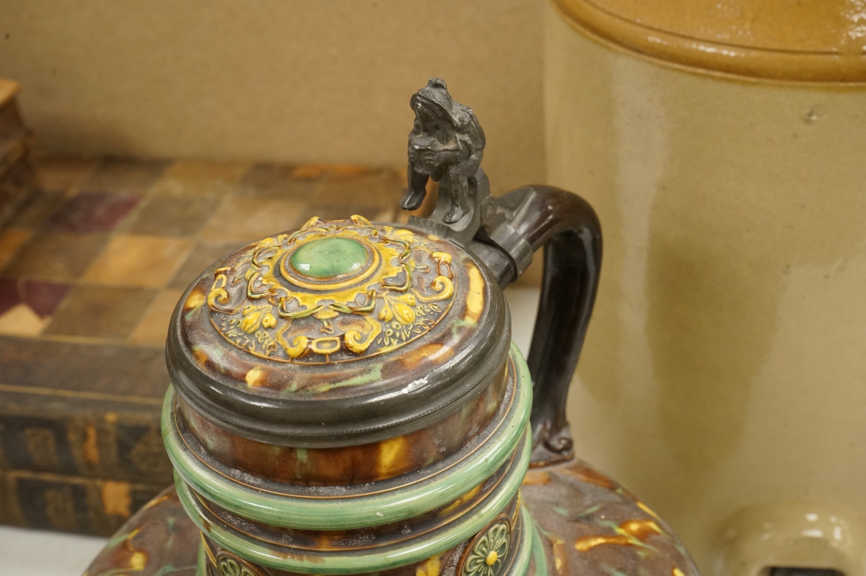 A German earthenware flagon, 32cm tall, together with a Beard & Co of Lewes stoneware liqueur flask